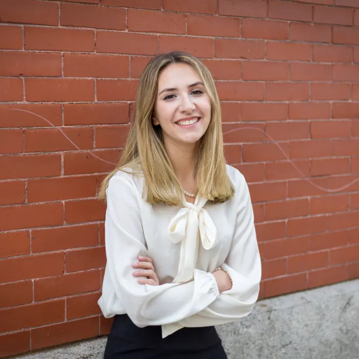 Confident young woman smiling with her arms folded – building self-esteem